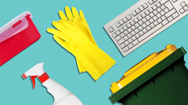 cleaning gloves, a spray bottle, a recycling bin and a computer keyboard on a teal background